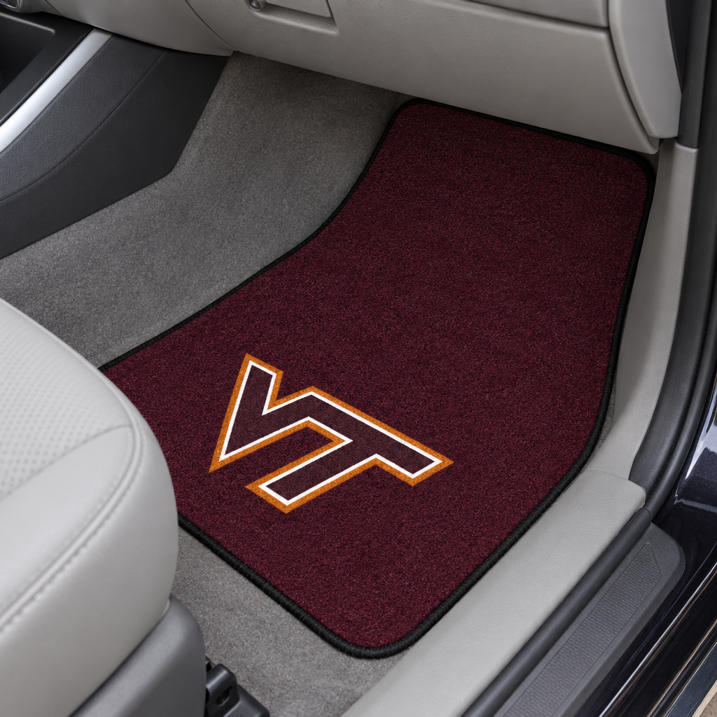 Maroon car mat with a logo on a beige car interior