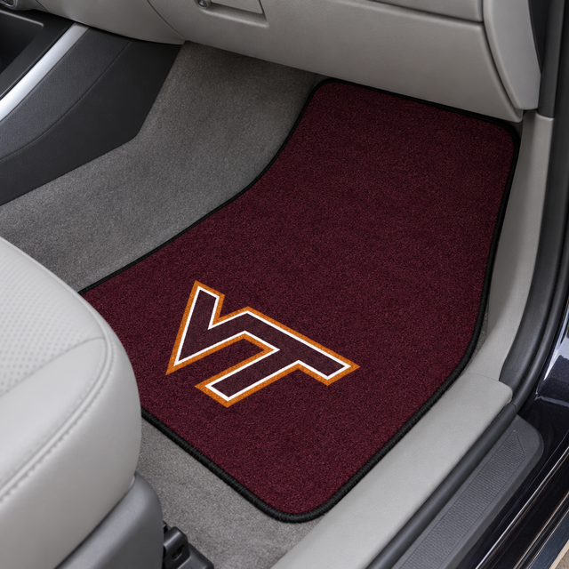 Maroon car mat with a logo on a beige car interior