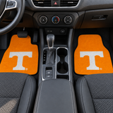 Two orange car floor mats with a white 'T' logo on a white background