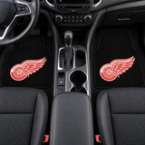 Two black car floor mats with a red and white logo on a white background