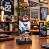 Tennessee Titans-themed totem pole figurine with cartoon character on top, set against a natural background.